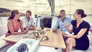 Guests enjoying a meal on yacht deck